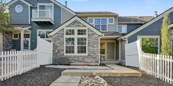 Image 2: Bright daytime exterior highlighting the home's charming stone facade, private courtyard, and low-maintenance landscaping. Image 2: Bright daytime exterior highlighting the home's charming stone facade, private courtyard, and low-maintenance landscaping.