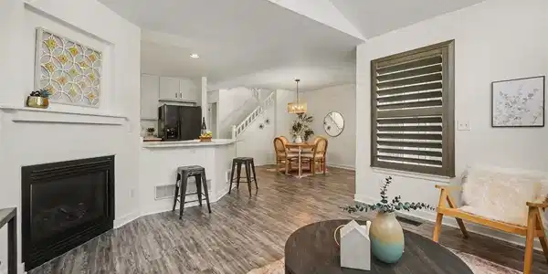 Image 4: Open-concept living area with a cozy gas fireplace and seamless flow into the kitchen and dining spaces. Image 4: Open-concept living area with a cozy gas fireplace and seamless flow into the kitchen and dining spaces.