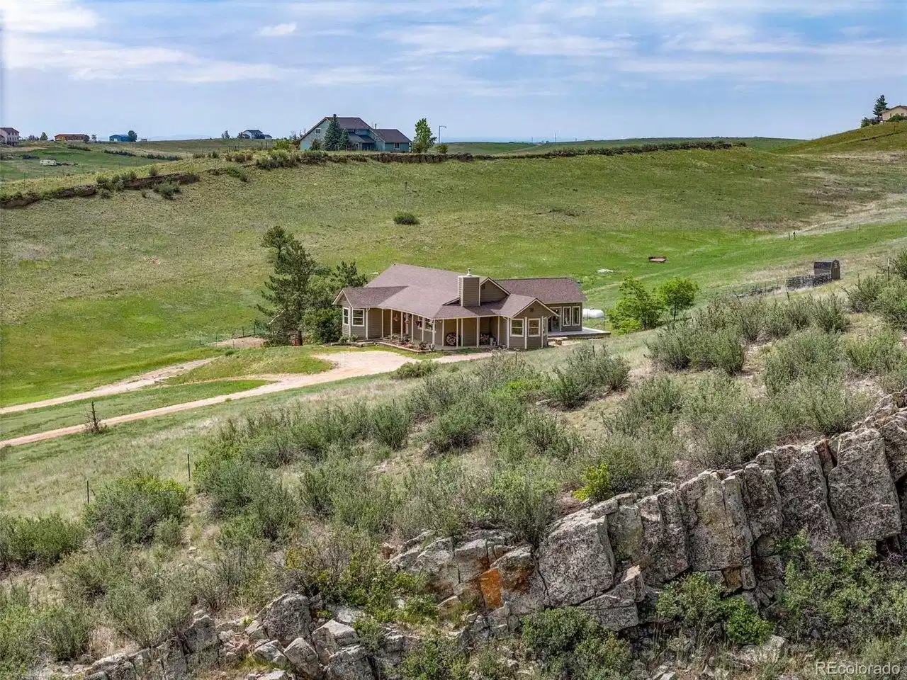 Image 1: Welcome to 5821 W County Road 8E. A glimpse of the home nestled into the surrounding landscape. Image 1: Welcome to 5821 W County Road 8E. A glimpse of the home nestled into the surrounding landscape.