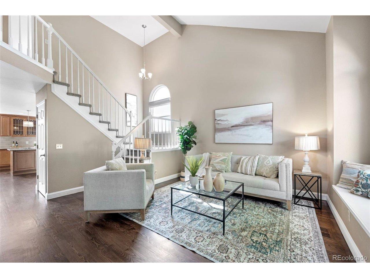 Image 2: Beautiful entry, the living room features vaulted ceilings, lots of natural light, a bay window with seating, and decorative stairway. Image 2: Beautiful entry, the living room features vaulted ceilings, lots of natural light, a bay window with seating, and decorative stairway.