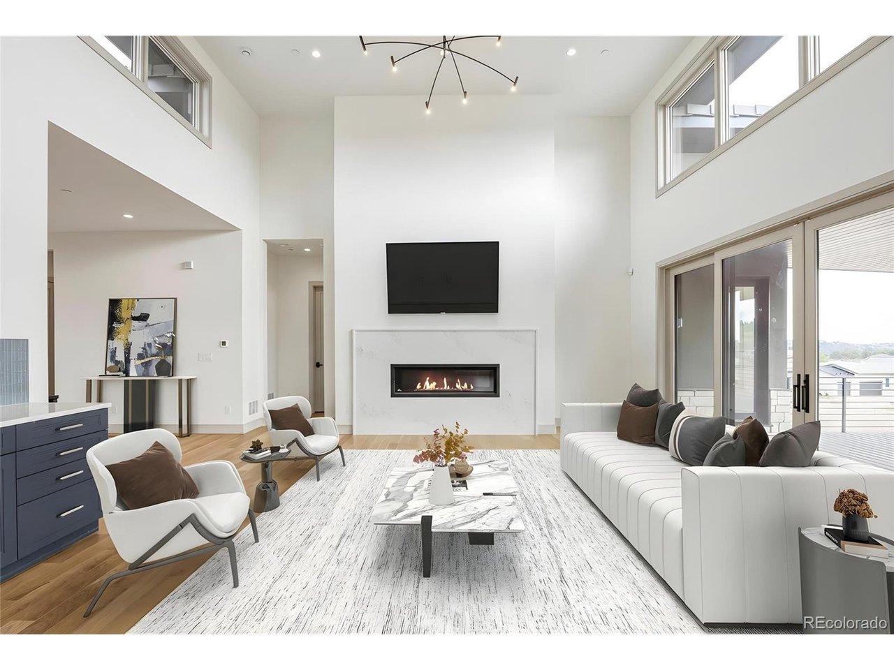 Image 3: The great room centers around a statement linear gas fireplace and opens through expansive sliding doors to a covered deck with tongue-and-groove ceiling and dry-below system, providing seamless indoor-outdoor gatherings to enjoy Colorado living year-round Image 3: The great room centers around a statement linear gas fireplace and opens through expansive sliding doors to a covered deck with tongue-and-groove ceiling and dry-below system, providing seamless indoor-outdoor gatherings to enjoy Colorado living year-round