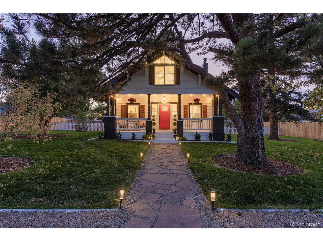 Image 1: Captivating Curb Appeal. Experience the tranquility of this enchanting residence, framed by mature, whispering trees and illuminated by a custom flagstone path. A picturesque front porch and vibrant door invite you to discover the charm within.Front of hom