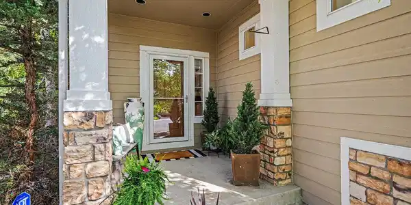 Image 2: Welcoming covered front entry with stone accents
