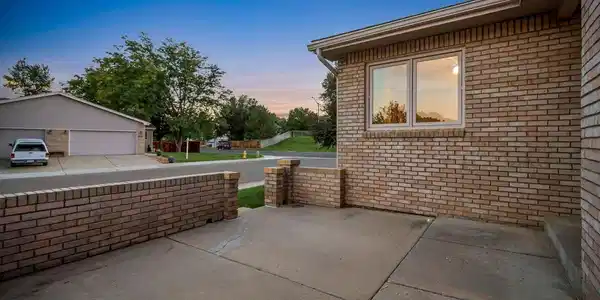 Image 2: Front courtyard with half wall creating another inviting outdoor space Image 2: Front courtyard with half wall creating another inviting outdoor space