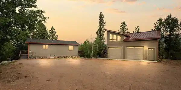 Image 2: As twilight settles over the treetops, this home comes alive with warm, inviting light spilling from every window. The wide, level driveway offers effortless parking for family and friends, while the glow of dusk transforms the mountainside into something Image 2: As twilight settles over the treetops, this home comes alive with warm, inviting light spilling from every window. The wide, level driveway offers effortless parking for family and friends, while the glow of dusk transforms the mountainside into something