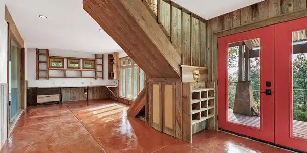 Image 3: Reclaimed wood, custom built-ins, and a dramatic open stairway give this inviting space its unmistakable architectural character. Image 3: Reclaimed wood, custom built-ins, and a dramatic open stairway give this inviting space its unmistakable architectural character.