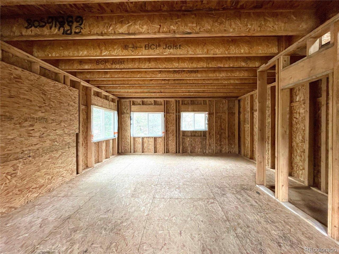 Image 4: Living room downstairs with kitchen area - unfinished Image 4: Living room downstairs with kitchen area - unfinished