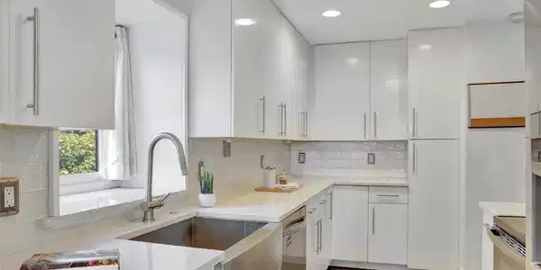 Image 2: Updated kitchen featuring quartz countertops, modern cabinetry, stainless steel appliances, and abundant storage.