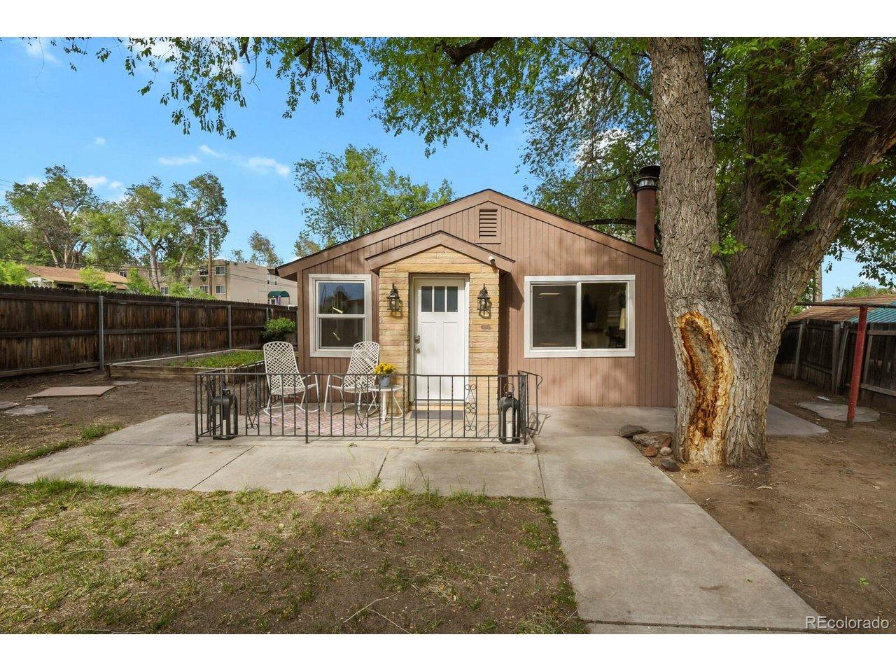 Image 2: Front of the home with front patio and yard that wraps around Image 2: Front of the home with front patio and yard that wraps around