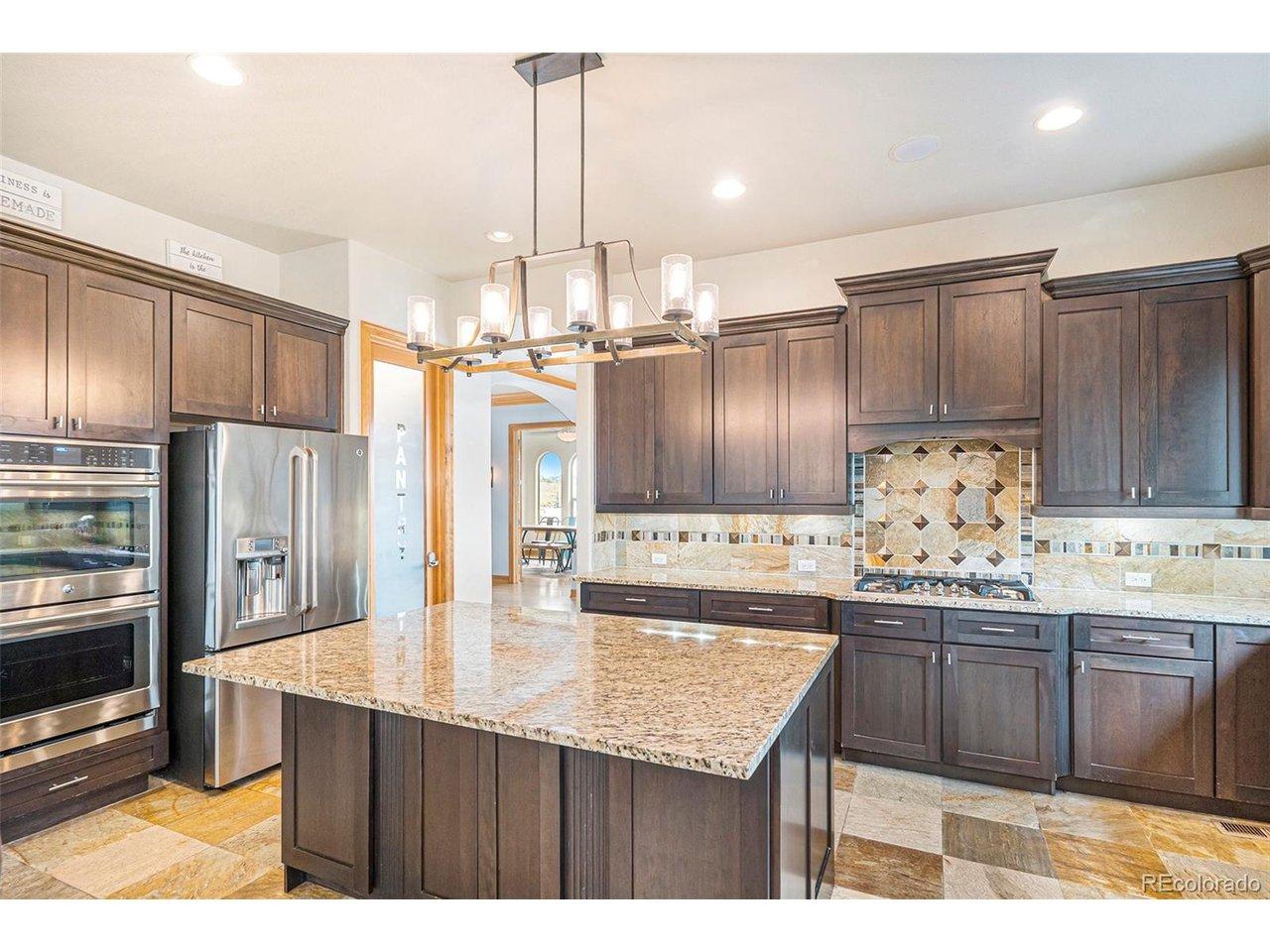 Image 4: Slab granite counters & walnut cabinets..