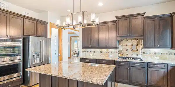 Image 4: Slab granite counters & walnut cabinets.. Image 4: Slab granite counters & walnut cabinets..