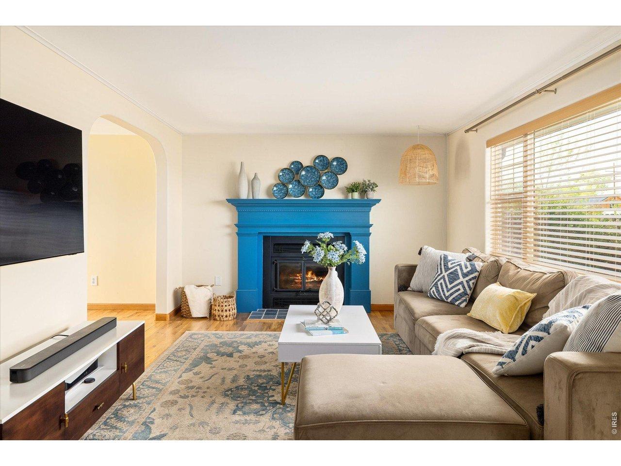 Image 2: bright and inviting living area with hardwood floors, abundant natural light and a cozy fireplace Image 2: bright and inviting living area with hardwood floors, abundant natural light and a cozy fireplace
