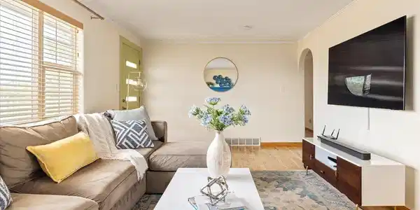 Image 4: bright and welcoming living room with hardwood floors, and an open layout that flows easily to adjacent spaces