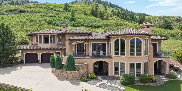 Image 2: Nestled against the breathtaking backdrop of Roxborough Park's rolling foothills, this extraordinary custom estate offers a rare combination of architectural elegance, privacy, and unparalleled natural beauty. Award winning architect KGA Architects.
