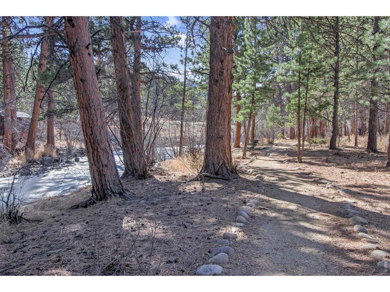 Image 3: Stone lined walking path following The Big Thompson River just out the back door.