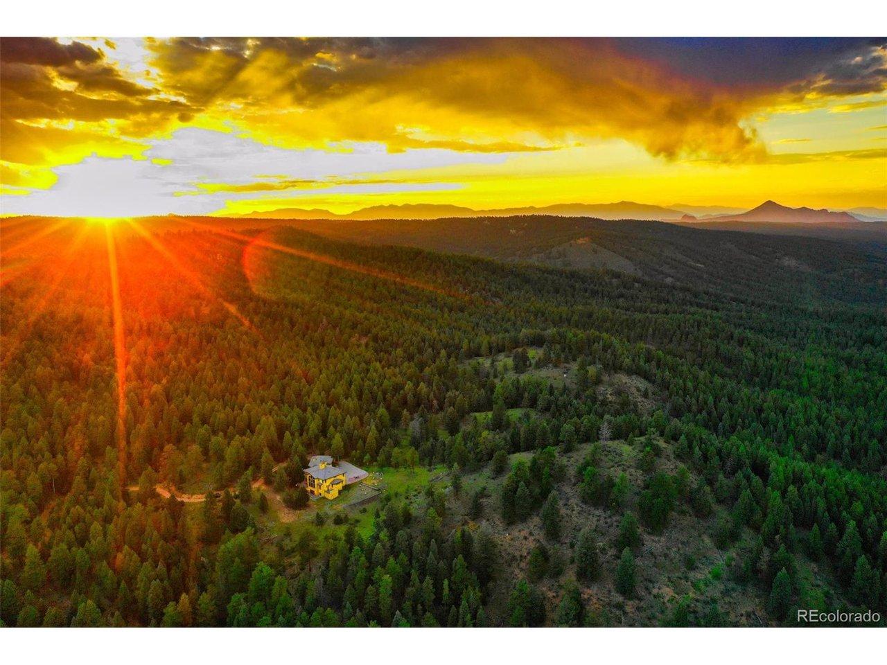 Image 3: Beautiful aerial over the property and home boardered on 2 sides by national forest and one side by the wooded portion of the golf course.