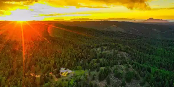 Image 3: Beautiful aerial over the property and home boardered on 2 sides by national forest and one side by the wooded portion of the golf course. Image 3: Beautiful aerial over the property and home boardered on 2 sides by national forest and one side by the wooded portion of the golf course.