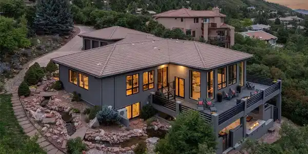 Image 3: Dramatic twilight exterior showcasing the home's contemporary architecture against iconic Red Rock formations