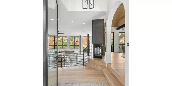 Image 4: Grand entry with soaring ceilings, arched doorways, and sightlines straight through to the Red Rock formations