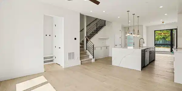Image 3: Designed for effortless living & entertaining, the open-concept main level flows seamlessly between the living, dining & kitchen spaces.