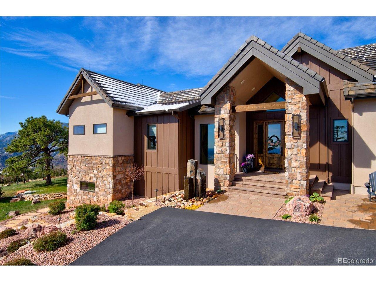 Image 3: Welcome home. Distinctive front elevation showcasing custom stone columns, board-and-batten siding, knotty alder double doors, and a tranquil basalt water feature at the entry. Image 3: Welcome home. Distinctive front elevation showcasing custom stone columns, board-and-batten siding, knotty alder double doors, and a tranquil basalt water feature at the entry.