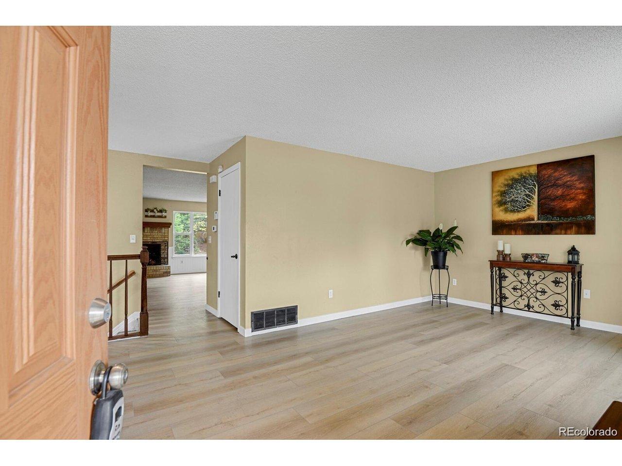 Image 4: Front living room with beautiful new Luxury Vinyl Plank flooring Image 4: Front living room with beautiful new Luxury Vinyl Plank flooring