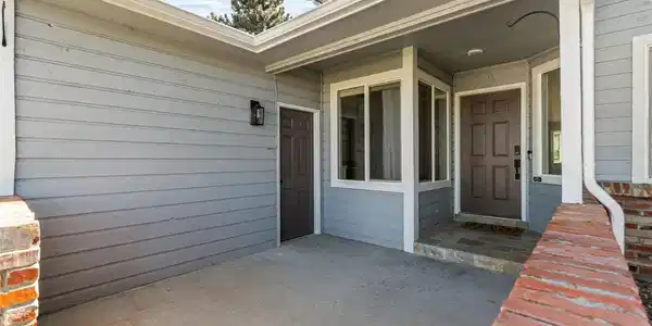 Image 2: A spacious covered front porch creates a welcoming entrance with plenty of room for seating and seasonal decor. Image 2: A spacious covered front porch creates a welcoming entrance with plenty of room for seating and seasonal decor.