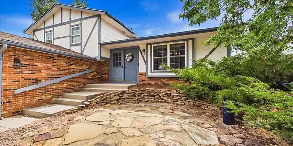 Image 3: Welcoming front entrance highlighted by a flagstone patio, attractive landscaping, and charming architectural details. Image 3: Welcoming front entrance highlighted by a flagstone patio, attractive landscaping, and charming architectural details.