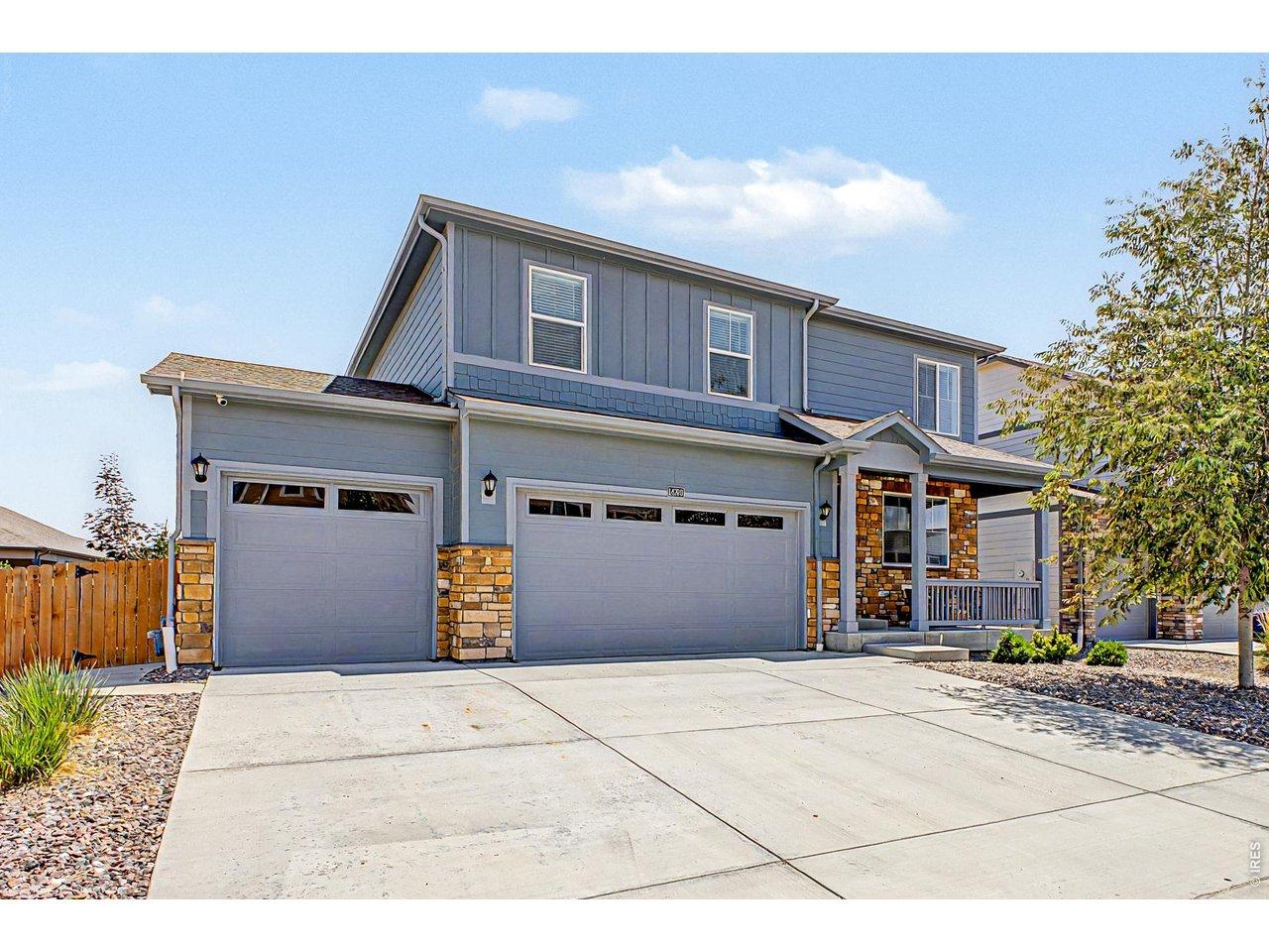 Image 2: Bring the toys, tools, and projects. The oversized three-car garage includes overhead storage and an EV outlet ready for Colorado living.