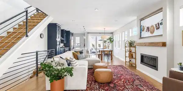 Image 3: The first impression is polished yet inviting. Natural white oak floors immediately establish the home's elevated aesthetic, while carefully selected lighting and refined finishes hint at the custom details to come.