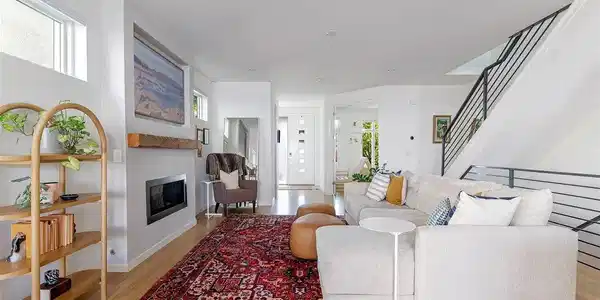 Image 4: The wider footprint is immediately apparent, giving the main level a wonderful sense of volume and allowing the living, dining and kitchen spaces to each feel substantial without losing their relationship to one another.