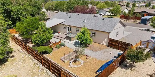 Image 3: Fenced, landscaped backyard with mature trees, hot tub, raised garden beds Image 3: Fenced, landscaped backyard with mature trees, hot tub, raised garden beds