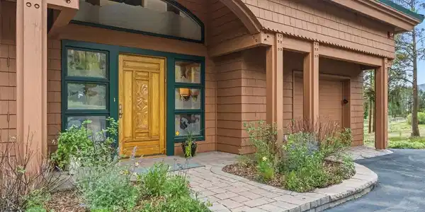 Image 3: Custom etched-glass entry welcomes you to experience this detail-rich home.