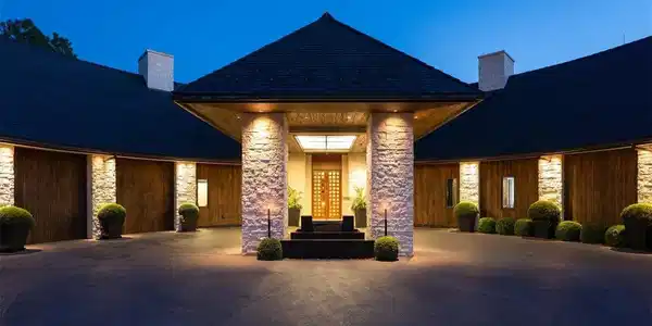 Image 4: Front exterior of the home showing views of its circular driveway and dramatic entrance.