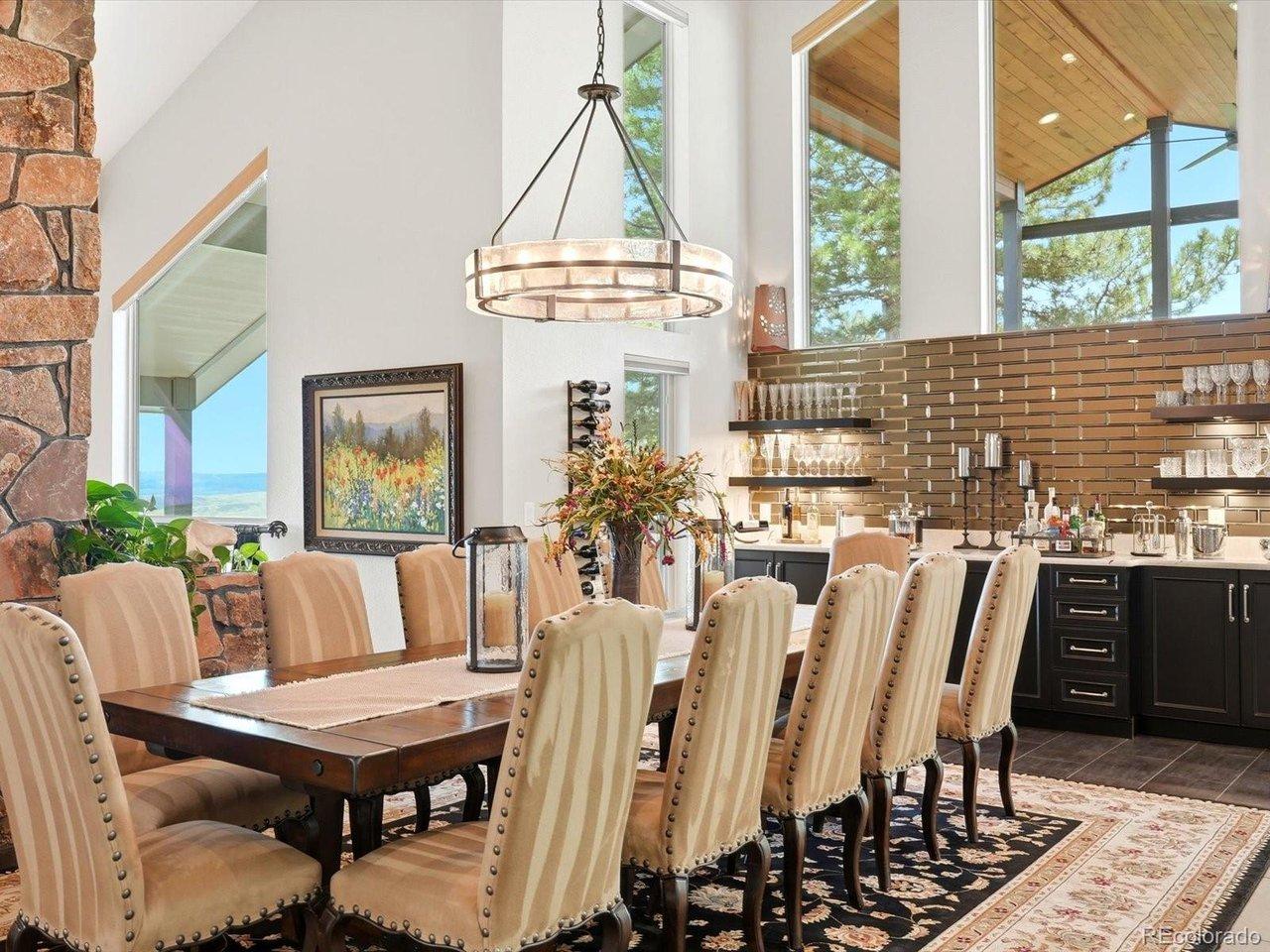 Image 3: Dining area with beautiful beverage center. Opens to kitchen and outdoor covered deck with breathtaking views! Image 3: Dining area with beautiful beverage center. Opens to kitchen and outdoor covered deck with breathtaking views!