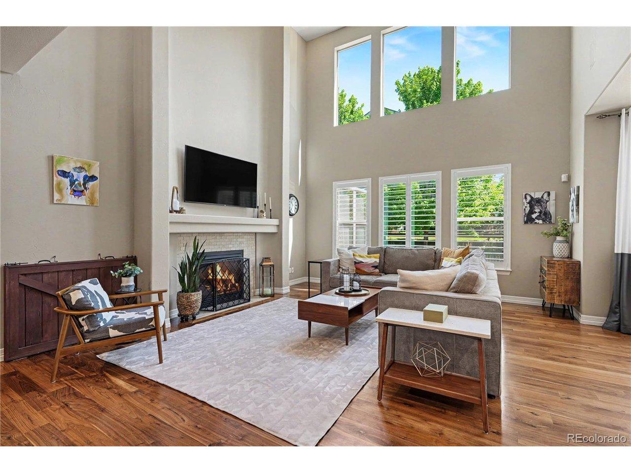 Image 4: Vaulted ceilings allow the natural light to flow through the living room with shutters and a gas fireplace Image 4: Vaulted ceilings allow the natural light to flow through the living room with shutters and a gas fireplace
