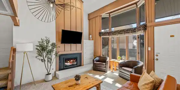 Image 2: Bright, sun-filled living room with soaring windows and a cozy fireplace. Comfortable seating makes it the perfect spot for morning coffee or relaxing after a day on the slopes. Image 2: Bright, sun-filled living room with soaring windows and a cozy fireplace. Comfortable seating makes it the perfect spot for morning coffee or relaxing after a day on the slopes.