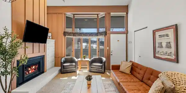Image 3: Relax by the fireplace in this bright, inviting living room with large windows and cozy seating. Perfect for morning coffee, apr s-ski drinks, or winding down with a movie after a day in the mountains. Image 3: Relax by the fireplace in this bright, inviting living room with large windows and cozy seating. Perfect for morning coffee, apr s-ski drinks, or winding down with a movie after a day in the mountains.