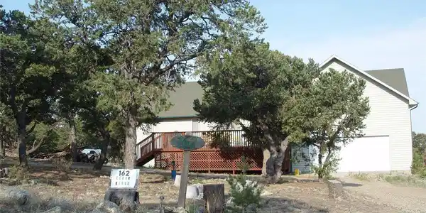 Image 3: The front of the house has nice pinon trees surrounding the home. Pinon nuts are a local favorite nut. You can pick your own crop. Image 3: The front of the house has nice pinon trees surrounding the home. Pinon nuts are a local favorite nut. You can pick your own crop.