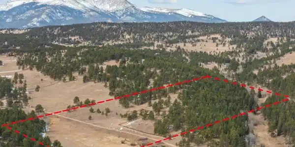 Image 3: Drone view and approximate outline of the 20.29-acre lot. Image 3: Drone view and approximate outline of the 20.29-acre lot.