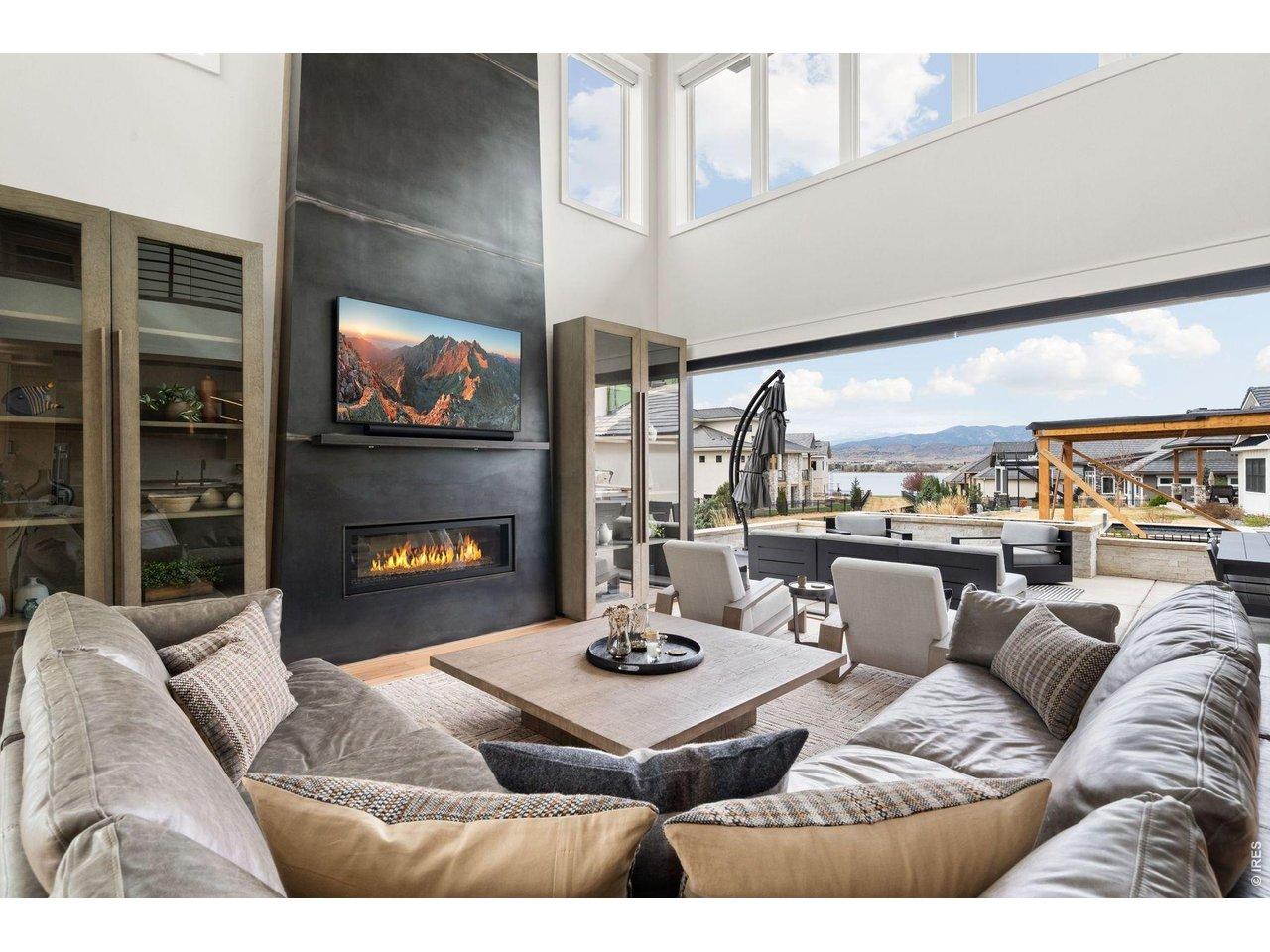 Image 4: Living room with 21ft ceilings and 18 ft accordion door with lake and mountain views Image 4: Living room with 21ft ceilings and 18 ft accordion door with lake and mountain views