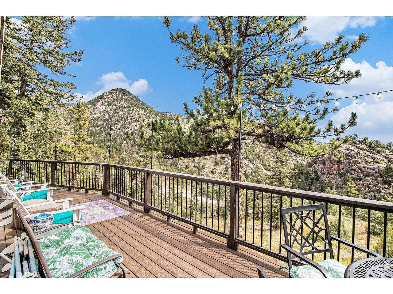 Image 2: Expansive deck overlooking the surrounding mountains and pines
