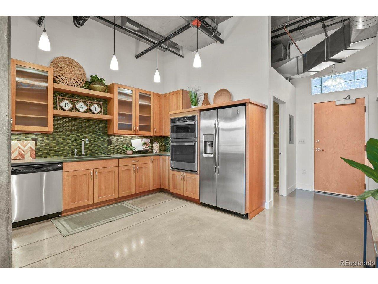 Image 4: stainless steel appliances including a new oven and microwave, and glass tile accents Image 4: stainless steel appliances including a new oven and microwave, and glass tile accents