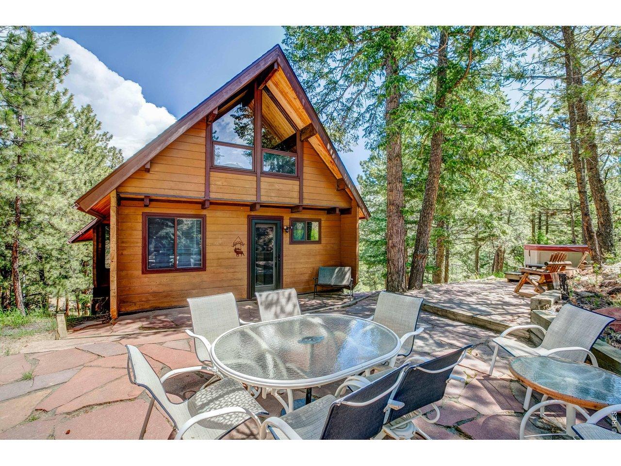Image 2: Inviting mountain cabin with a spacious outdoor patio