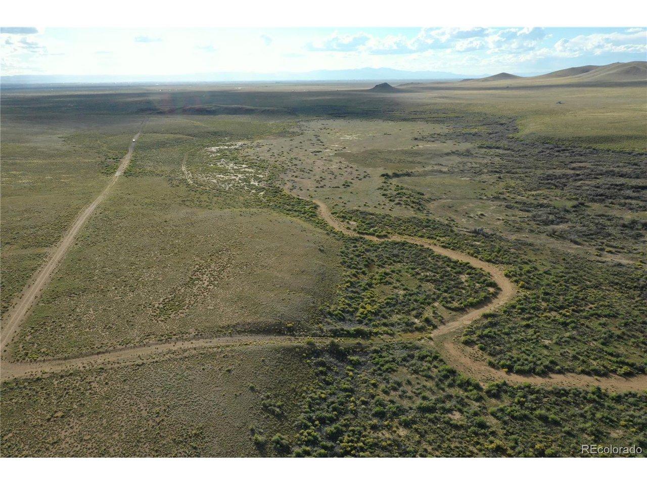 Image 1: Aerial view looking west, mostly level with rolling hills and natural vegetation.