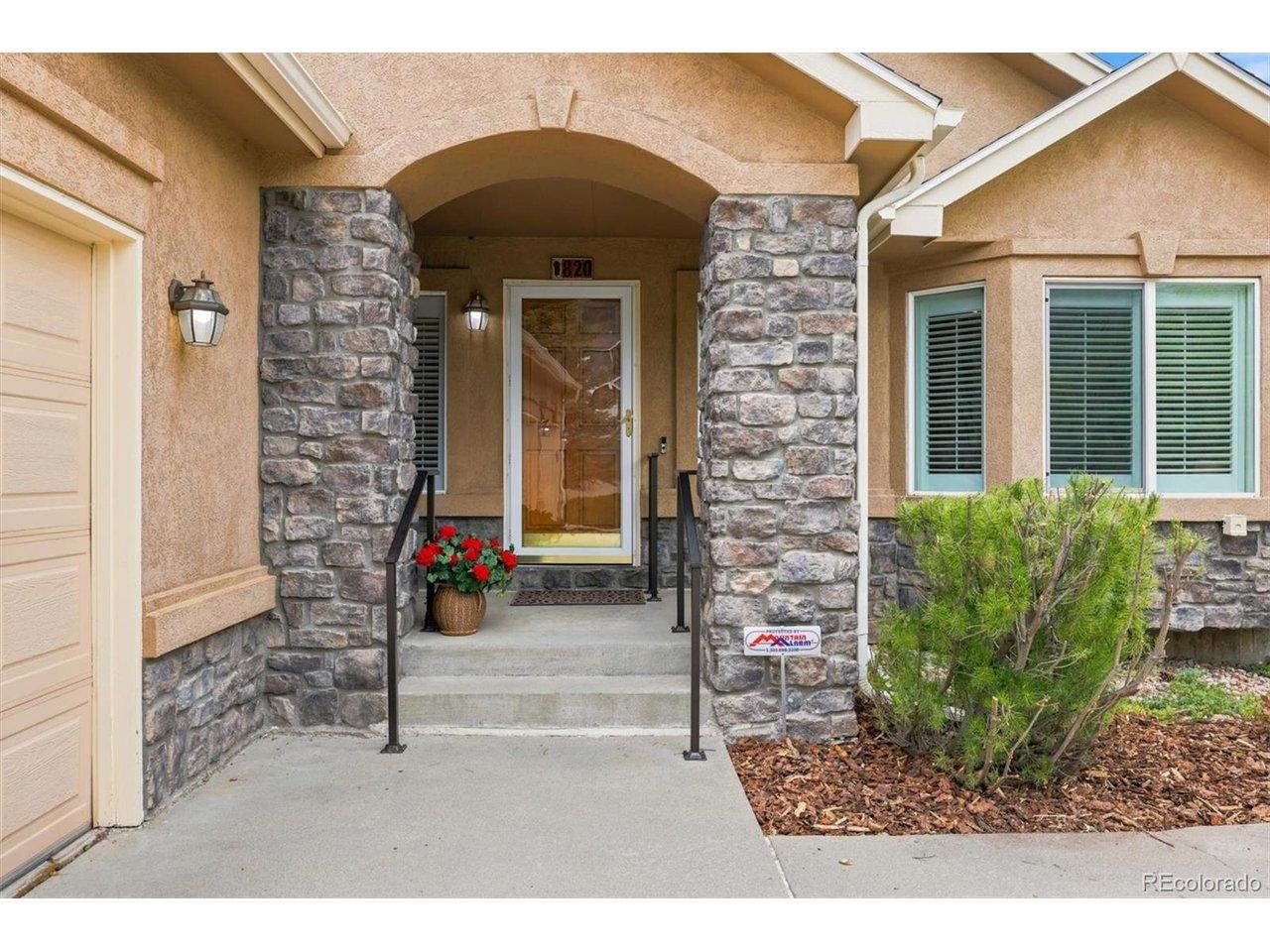 Image 3: Covered and welcoming front porch with sitting nook creating a quiet spot for enjoying the afternoon sunsets.