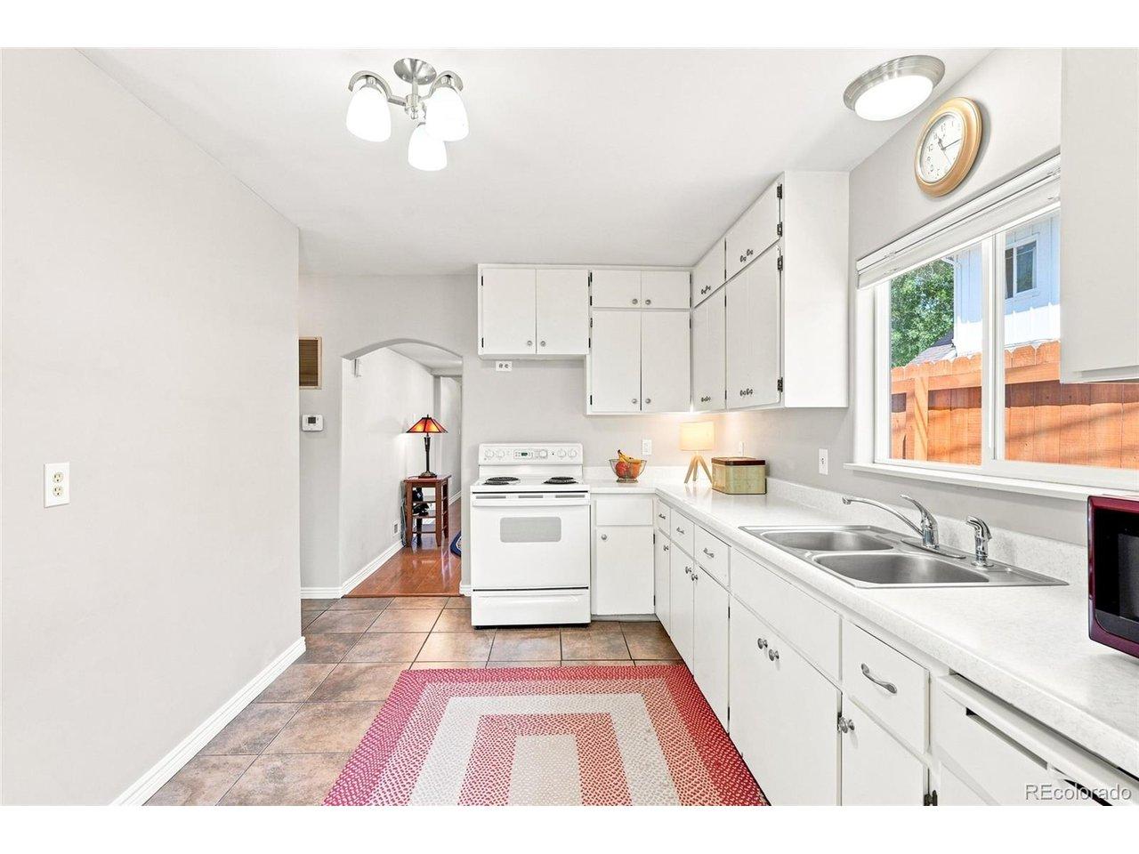 Image 4: Morning coffee comes easy in this crisp, sunlit galley kitchen at 317 3rd Ave Image 4: Morning coffee comes easy in this crisp, sunlit galley kitchen at 317 3rd Ave