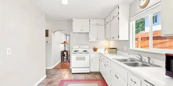 Image 4: Morning coffee comes easy in this crisp, sunlit galley kitchen at 317 3rd Ave Image 4: Morning coffee comes easy in this crisp, sunlit galley kitchen at 317 3rd Ave