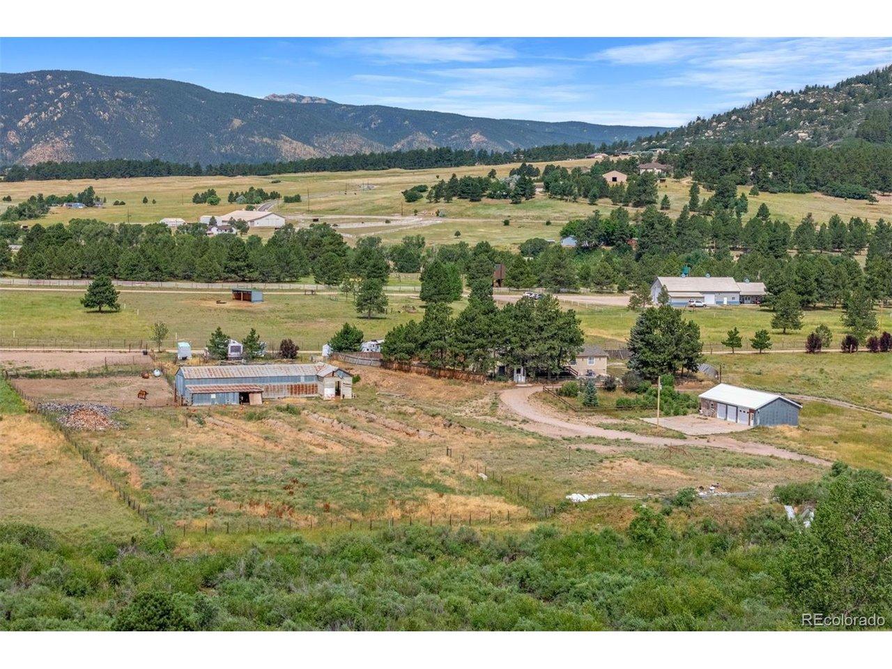Image 4: The property is fully fenced, with a detached three-car insulated garage featuring a finished workshop with heat and electric, and an original homestead barn from the 1930s. Image 4: The property is fully fenced, with a detached three-car insulated garage featuring a finished workshop with heat and electric, and an original homestead barn from the 1930s.