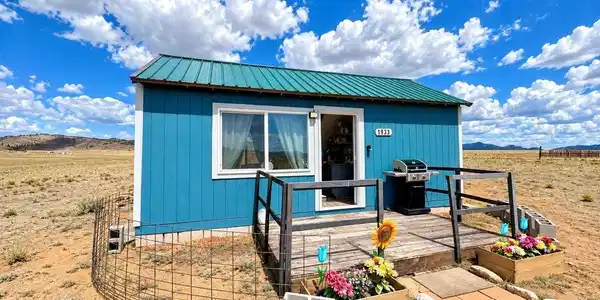 Image 3: Blue siding exterior with a green metal roof Image 3: Blue siding exterior with a green metal roof